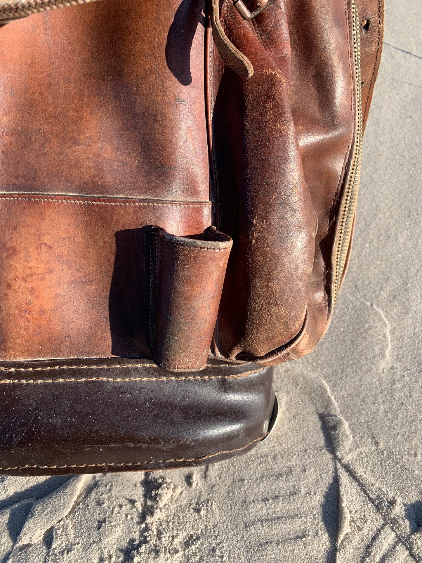 Gammel golfbag i læder med to gamle køller
