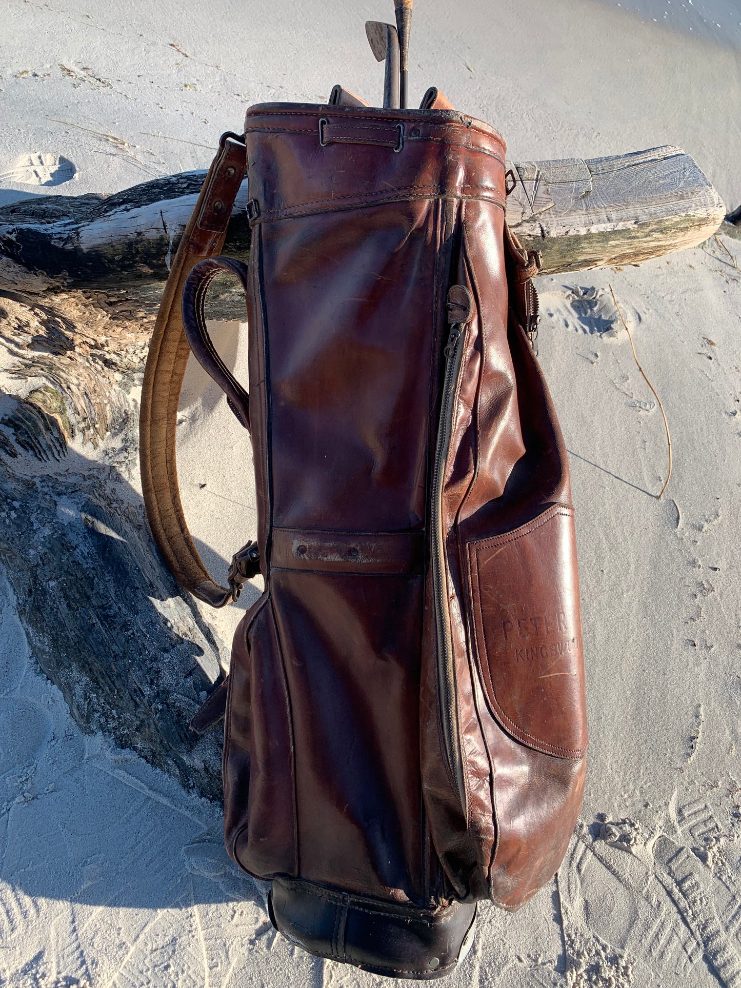 Gammel golfbag i læder med to gamle køller